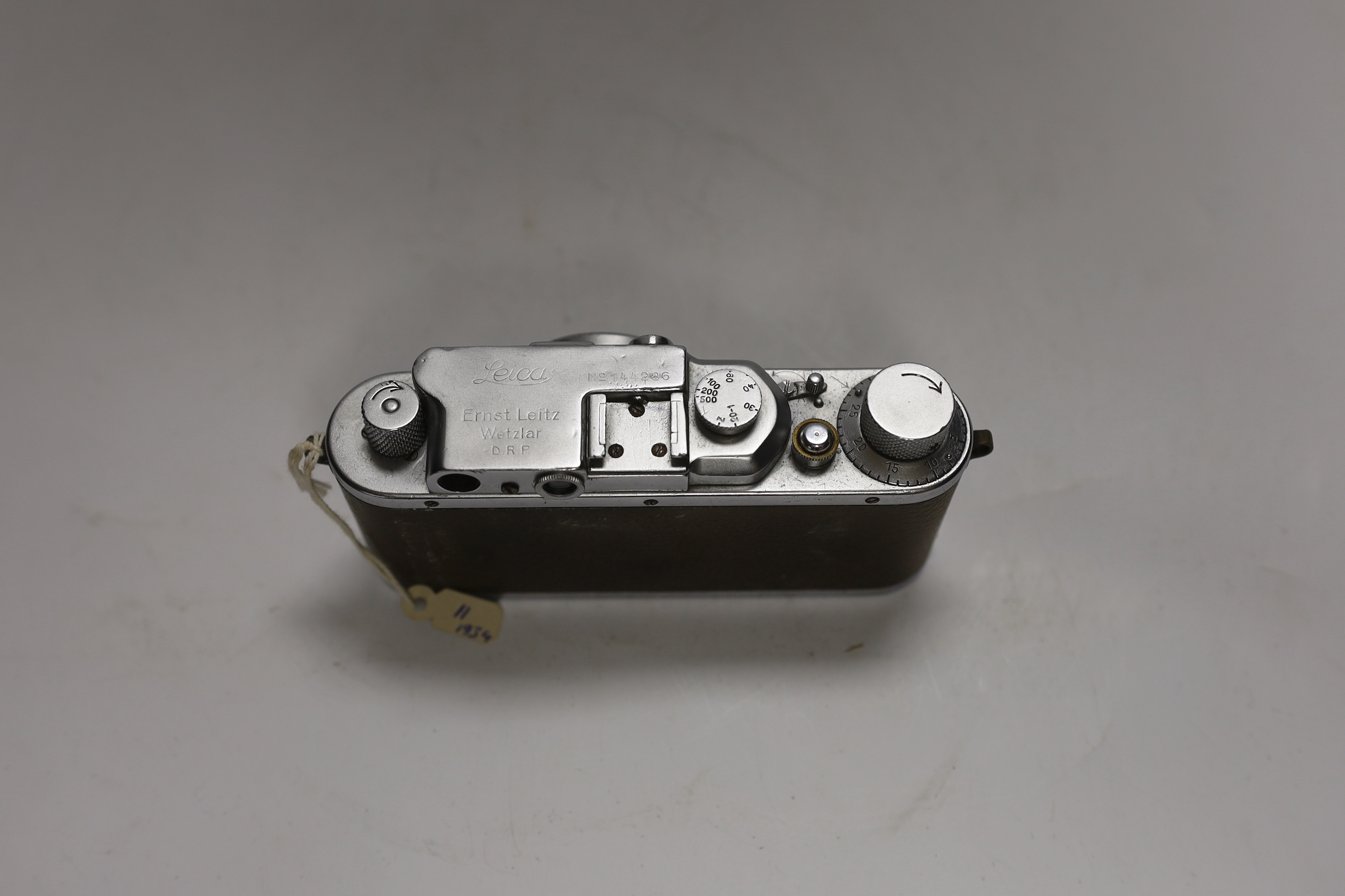 A Leica III camera, No.144286, with an Elmar f=5cm 1:3,5 lens, with leather case and strap